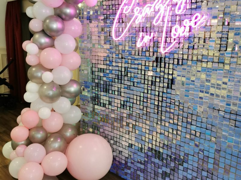 Neon sign - Crazy In Love - with sequin shimmer wall backdrop and balloon display for weddings, events and parties. Glamour events hire based in Chester